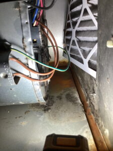 Interior view of the rusted blower cabinet showing some distortion and corrosion hidden within the cabinet.