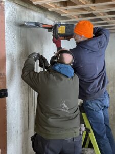 Cutting with water on a 10 degree day to install a new heat pump in Sudbury Massachusetts